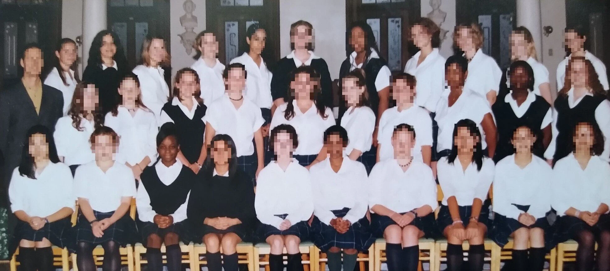 Kelly (first row, third from left) in secondary school